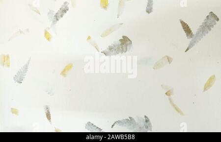White paper interspersed with leaves feathers and straws Stock Photo