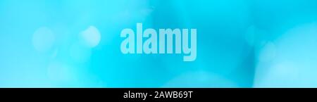 Panoramic simple light cerulean blue bokeh background. Website header background theme. Stock Photo