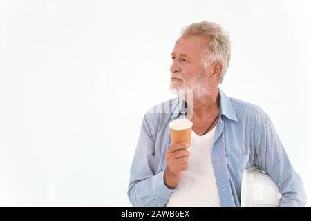 old man American Caucasian worker hand holding paper coffee cup wearing casual relax clothes looking away isolated on white background. Engineer Think Stock Photo