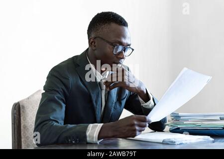 Black skinned confident guy posing employee has success at work Stock Photo