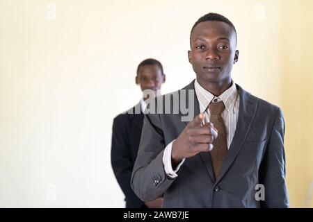 Couple of African handsome human concentrating	 chef in suit and tie Stock Photo
