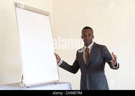 Authentic young Couple of business men together looking happy in the office with white board Stock Photo