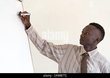 Close up shot of African Business CEO Man presenting presentation in front of Whiteboard Stock Photo