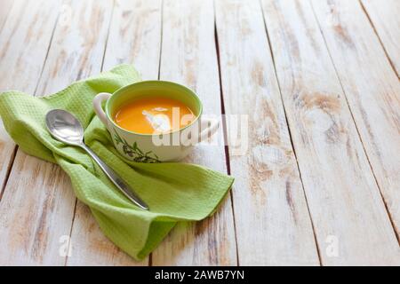 Puree soup, made from orange pumpkin, sweet potatoes and carrots, served with sour cream Stock Photo