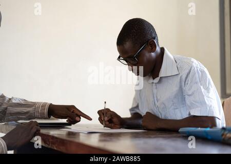 Handsome Young African Business People Signing a contract for a new job Stock Photo