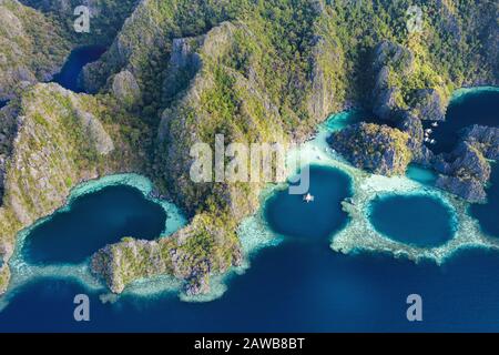 View from above, stunning aerial view of the Twin Lagoons surrounded by rocky cliffs. The Twin Lagoons are one of the must-see destinations in Coron. Stock Photo