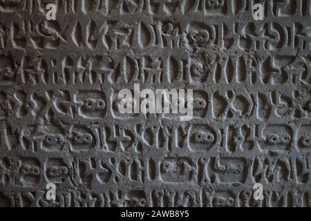 Engraved ancient stonewiht Old Alphabet letters writting from antique times Stock Photo