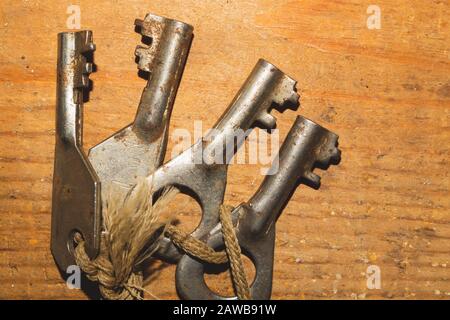 Bunch of old keys isolated on wooden background. safety and security concept Stock Photo
