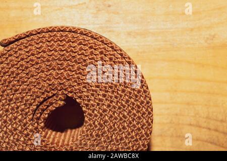 Industrial harness rolled up on a wooden table. work tool Stock Photo