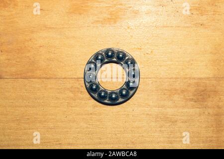 Metal bearing on a wooden table close up Stock Photo