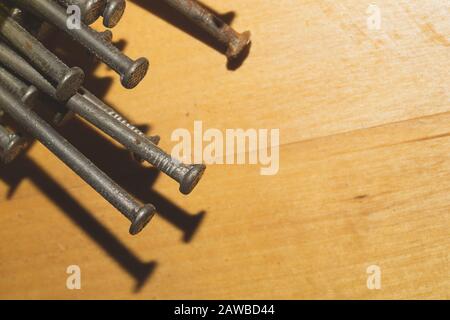 Nails on a wooden background.working tools. copy space Stock Photo