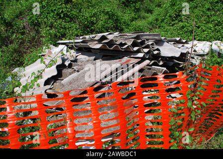 A pile of illegally dumped Asbestos sheets in a country lane. Italy Stock Photo