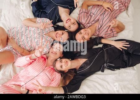 Beautiful ladies enjoying party and showing their tongues Stock Photo