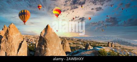 Colorful hot air balloons flying over at fairy chimneys in Nevsehir, Goreme, Cappadocia Turkey. Hot air balloon flight at Cappadocia Turkey Stock Photo