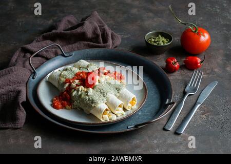 Mexican food - Papadzules traditional dish from the Yucatan Peninsula - corn tortillas dipped in a sauce of pumpkin seeds filled with boiled eggs, Stock Photo