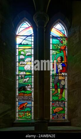 A 20th Century Stained Glass Window depicting a Pastoral Scene, within the Church of St Michael and All Angels next to Ford Castle in Northumberland. Stock Photo