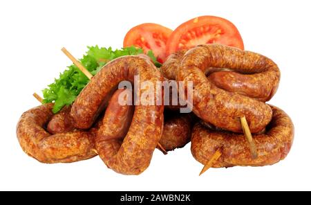 Group of savoury buffet mini party bratwurst sausage swirls isolated on a white background Stock Photo