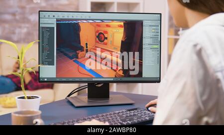 Close up shot of young woman game developer working on a new video game level in her house Stock Photo