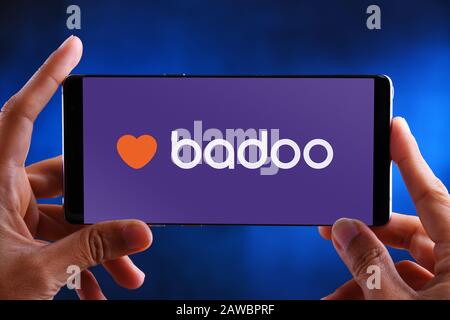 POZNAN, POL - JUL 10, 2019: Hands holding smartphone displaying logo of Badoo, the world's most widely-used dating network. Stock Photo