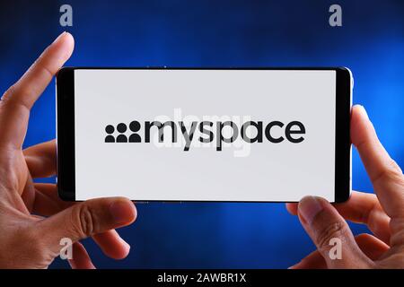 POZNAN, POL - JUL 10, 2019: Hands holding smartphone displaying logo of Myspace, a social networking website. Stock Photo