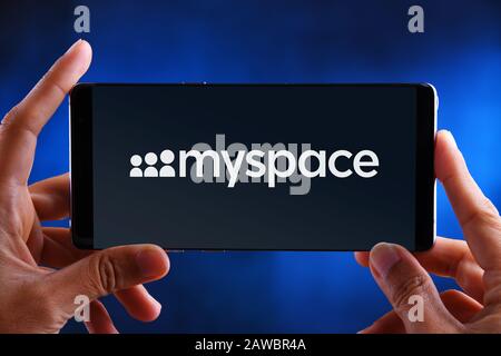 POZNAN, POL - JUL 10, 2019: Hands holding smartphone displaying logo of Myspace, a social networking website. Stock Photo