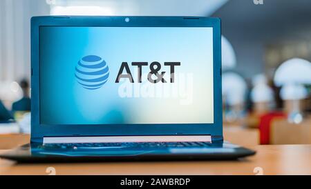 POZNAN, POL - DEC 11, 2019: Laptop computer displaying logo of AT&T Inc.,  the world's largest telecommunications company and the largest provider of Stock Photo