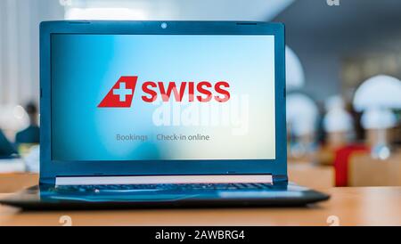 POZNAN, POL - DEC 11, 2019: Laptop computer displaying logo of Swiss Air Lines, the flag carrier of Switzerland Stock Photo