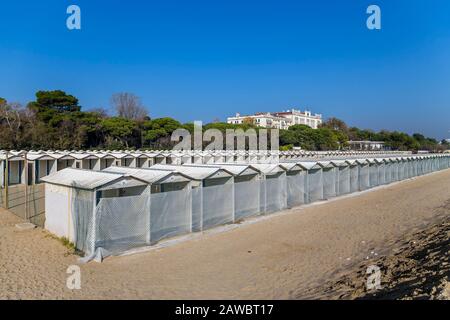 Deserted beach with small beach houses on the coast of the island of Lido in Venice. Italy Stock Photo