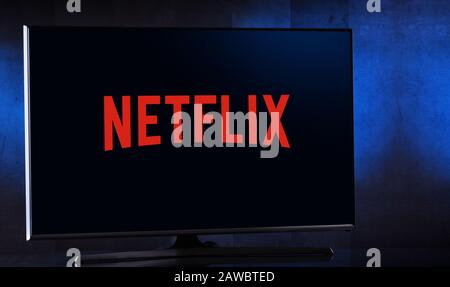 POZNAN, POL - FEB 04, 2020: Flat-screen TV set displaying logo of Netflix, an American media-services provider headquartered in Los Gatos, California, Stock Photo