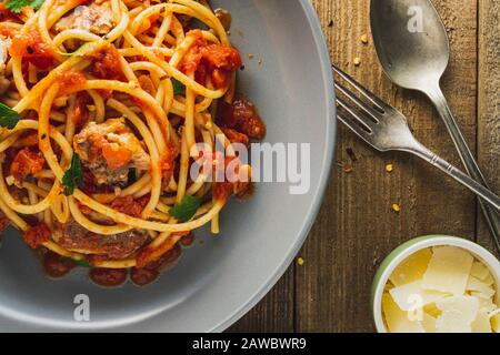 Bucatini pasta with Sardines in tomato sauce. Close-up. Stock Photo