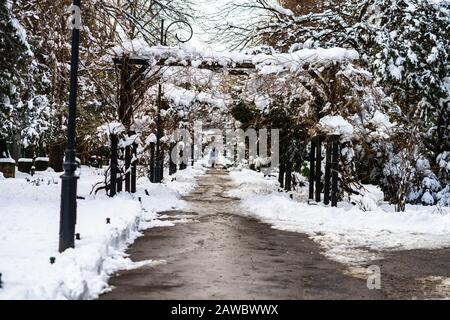 Path way made by people walking thru the snow in the park. Path in heavy snow. Winter concept snow-path in the evening light Stock Photo