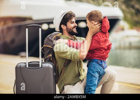 Happy father hugging little son arriving returning after long trip