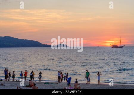 Sunset at Patong beach in Phuket. Phuket is large island and a popular travel destination in southern Thailand. Stock Photo