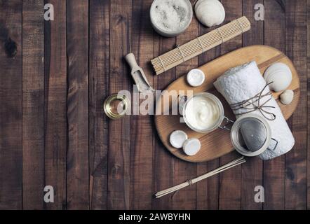Beauty treatment products on vintage wooden background. Spa cosmetic background. Flat lay. Stock Photo