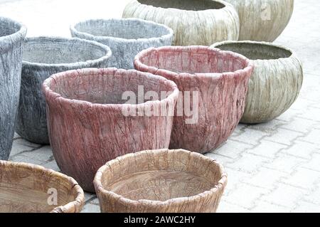 Synthetic resin handcrafted flower pots in pastel colors arranged for sale Stock Photo