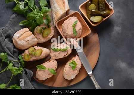 Chicken or goose liver pate sandwiches on a wooden board Stock Photo