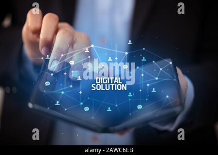 Businessman holding a foldable smartphone with DIGITAL SOLUTION inscription, new technology concept