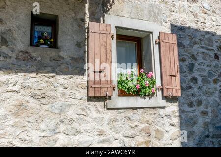 Small and big windows on the stone wall Stock Photo