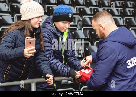 Swansea, UK. 08th Feb, 2020. Wayne Rooney of Derby County signs a young fans Manchester United shirt ahead of game. EFL Skybet championship match, Swansea city v Derby County at the Liberty Stadium in Swansea, South Wales on Saturday 8th February 2020. this image may only be used for Editorial purposes. Editorial use only, license required for commercial use. No use in betting, games or a single club/league/player publications. pic by Lewis Mitchell/Andrew Orchard sports photography/Alamy Live news Credit: Andrew Orchard sports photography/Alamy Live News Stock Photo