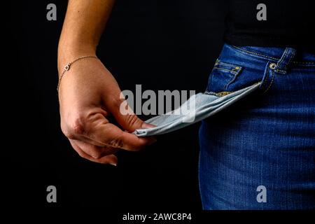 Woman turning her pockets inside out being broke
