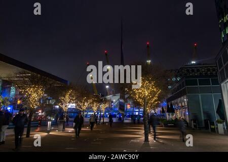 The exterior of the O2 Millennium Dome in North Greenwich, London with winter lights in the trees Stock Photo