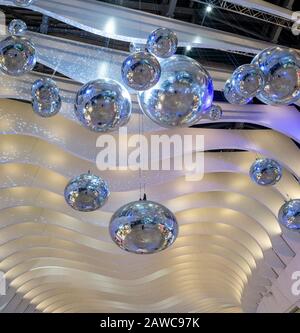 Large silver balls hang from the ceiling of the walkways of the Millennium Dome in London Stock Photo