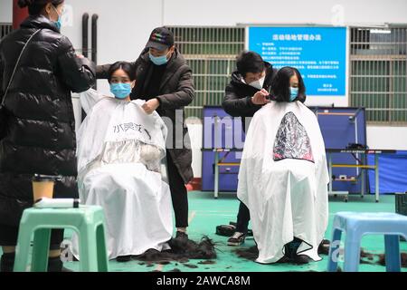 (200208) -- CHANGSHA, Feb. 8, 2020 (Xinhua) -- Medical team members have their hair cut to better wear protective products before leaving for Wuhan of Hubei Province, at the Third Xiangya Hospital of Central South University in Changsha, central China's Hunan Province, Feb. 8, 2020. Medical workers of the third batch from the Second Xiangya Hospital of Central South University and the first batch from the Third Xiangya Hospital of Central South University set off for Wuhan on Saturday, the Chinese Lantern Festival, to aid the novel coronavirus control efforts there. (Xinhua/Chen Zeguo) Stock Photo