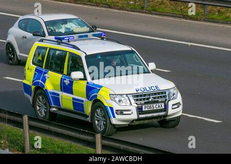 T2016 Mitsubishi Shogun SG2 DI-D LWB; Emergency response; Lancashire Tactical Operations division. UK Police Vehicular traffic, transport, modern, BMW saloon cars, north-bound on the 3 lane M6 motorway highway. Stock Photo