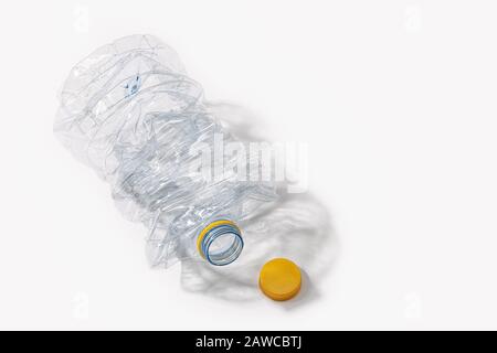 Crushed plastic bottle isolated on white background. Recycling concept. Copy space Stock Photo