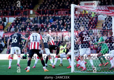 Brentford's Julian Jeanvier (centre) scores his side's first goal of the game during the Sky Bet Championship match at Griffin Park, London. Stock Photo