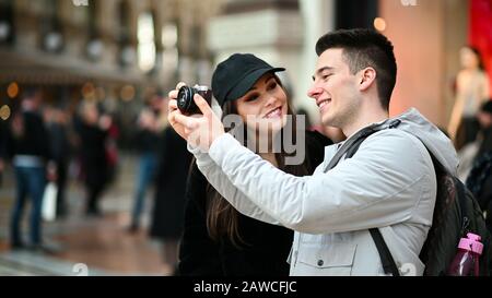 Young couple of turists taking pictures in the city Stock Photo