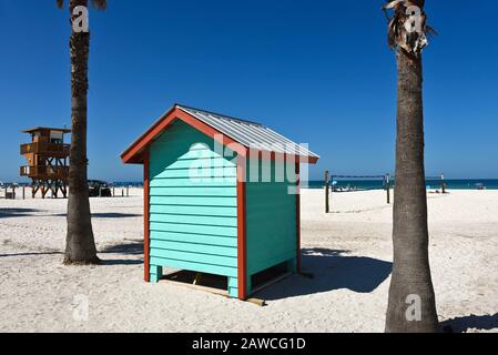 A colorful beach bath house on the sandy public beach area Stock Photo