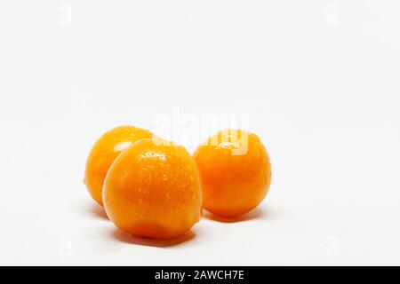three wet physalis fruits on white background Stock Photo