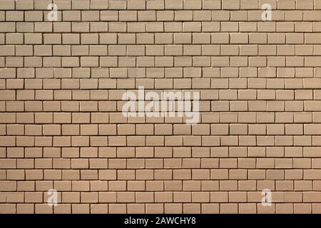Old brick wall painted over in light brown Stock Photo